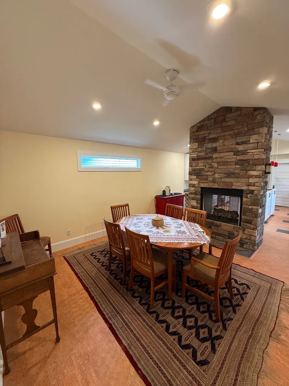 The dining side finished — Marmoleum flooring, new LED cans, and the fireplace surround replaced with tile