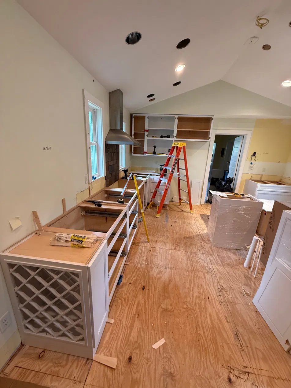 LED cans roughed in overhead and cabinet boxes going in during kitchen installation